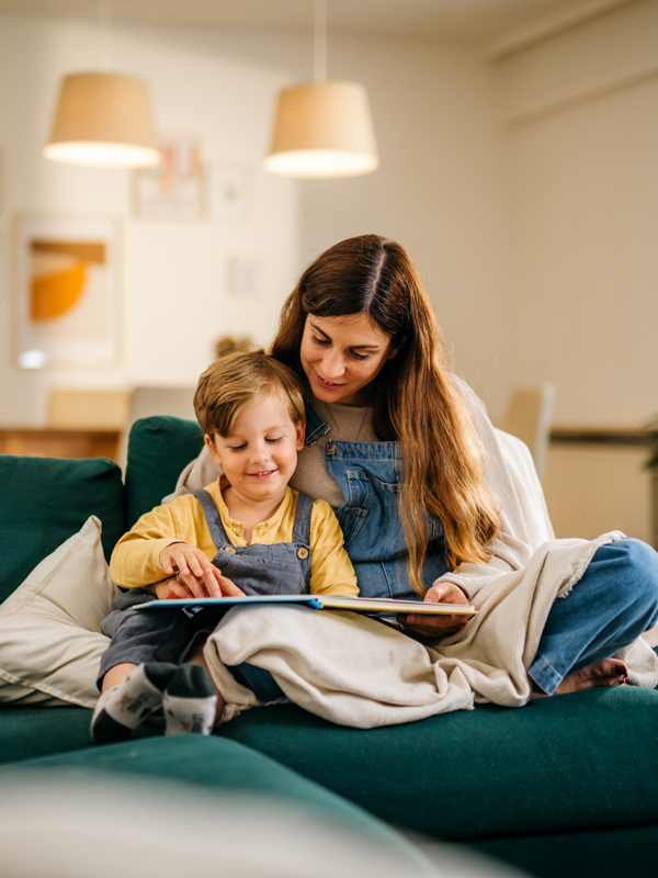 mother reading to child on couch